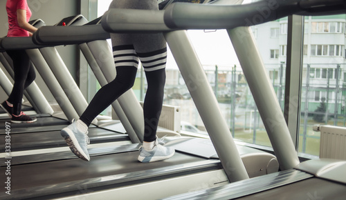 Healthy lifestyle concept. Female legs run on a treadmill in the gym © splitov27