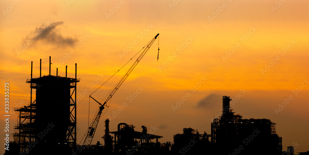 Crane and building construction site at sunset .Industry 4.0 concept . 