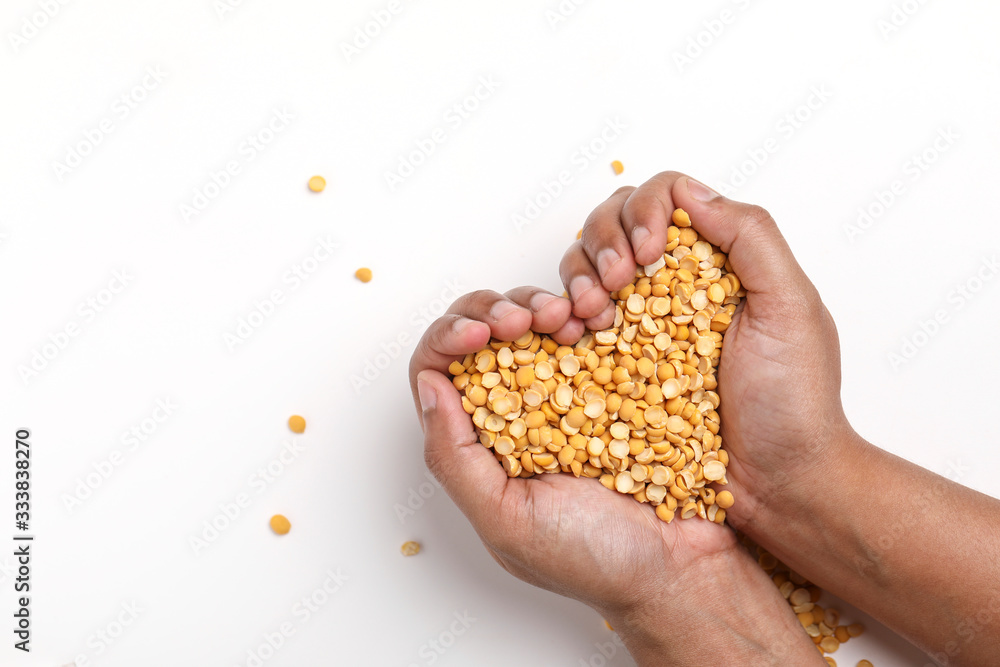 Fototapeta premium Dried chickpea lentils in wooden bowl on white background , Split Chickpea Also Know as Chana Dal