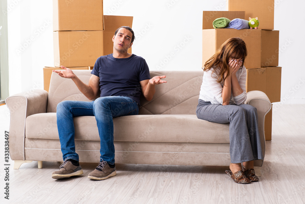 Young pair and many boxes in divorce settlement concept Young pair and many boxes in divorce settlement concept