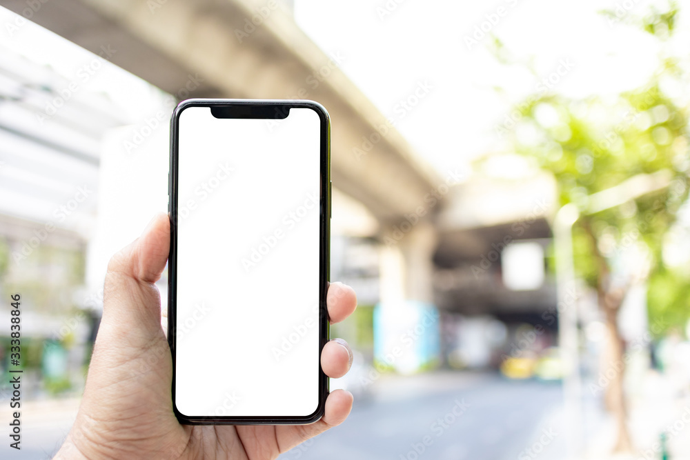 Asian man holding phone mock up left frame at street outdoor have environment train background  isolated display for insert screen