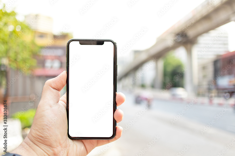 Asian man holding phone mock up left frame at street outdoor have environment city background isolated display for insert screen Asian man holding phone mock up left frame at street outdoor have environment city background isolated display for insert screen