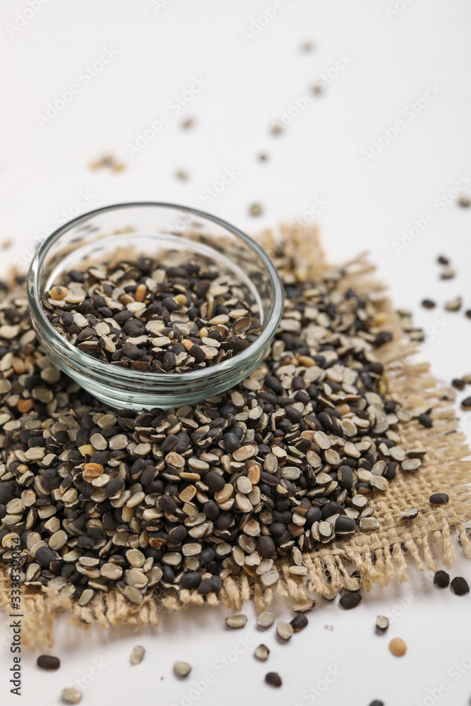 Split Black Lentil Also Know as Black Gram, Black Urad Dal, Vigna Mungo, Urad Beani glass bowl on white background Split Black Lentil Also Know as Black Gram, Black Urad Dal, Vigna Mungo, Urad Beani glass bowl on white background
