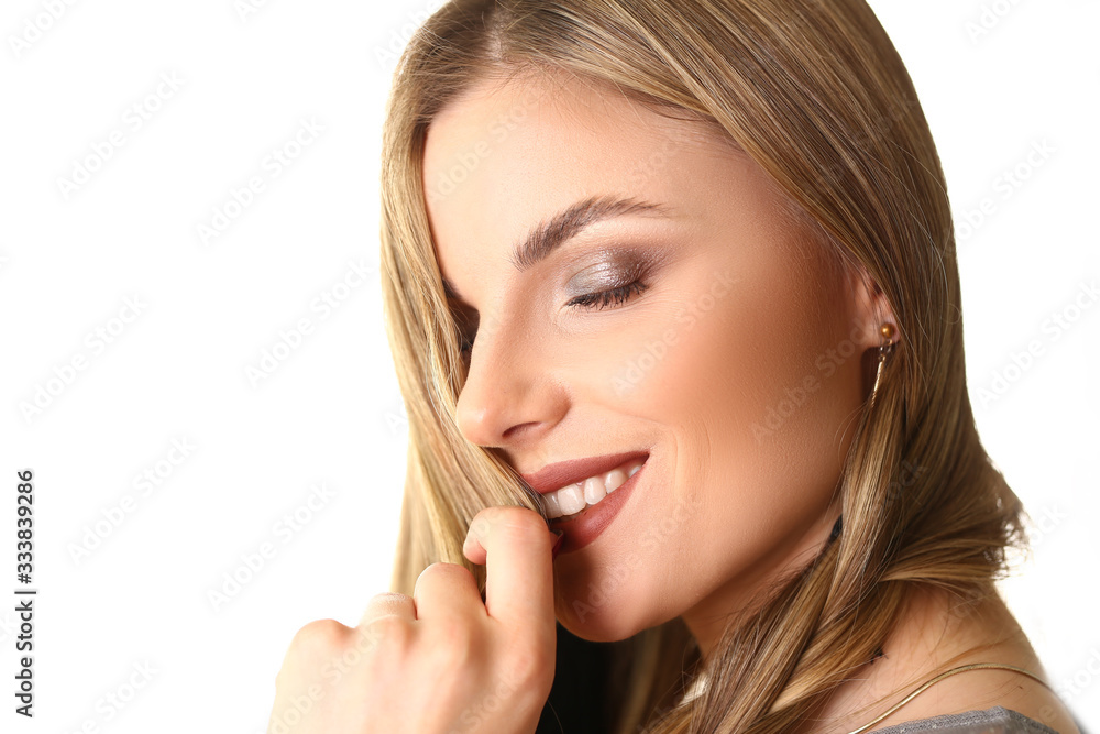 Closeup Headshot of Caucasian Female Beauty Model. Young Blond Trendy Woman with Natural Makeup and Red Lipstick Touching her Lips. Dreamy Girl Side View Headshot. Positive Shooting Closeup Headshot of Caucasian Female Beauty Model. Young Blond Trendy Woman with Natural Makeup and Red Lipstick Touching her Lips. Dreamy Girl Side View Headshot. Positive Shooting