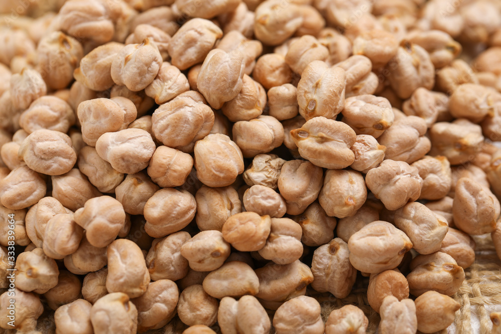 Uncooked dried chickpeas on white background