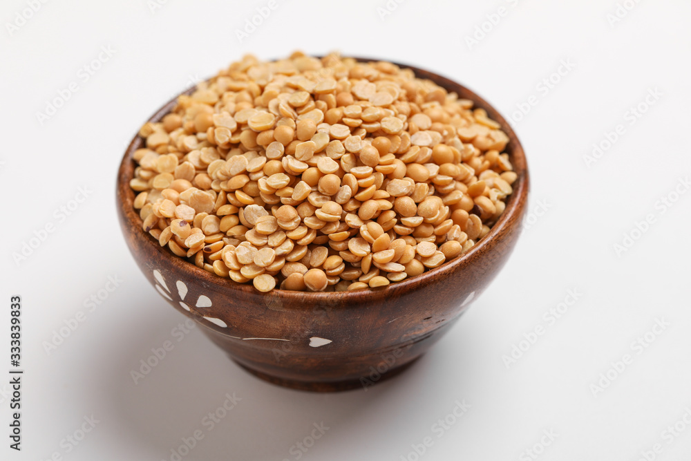 pigeon pea also known as toor dal in wooden bowl. pigeon pea also known as toor dal in wooden bowl.