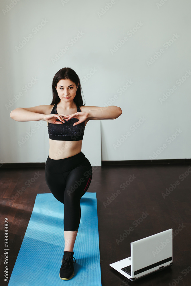 Home training, fitness, motivation concept. Young fit woman doing sport exercises in her living room. Home training, fitness, motivation concept. Young fit woman doing sport exercises in her living room.