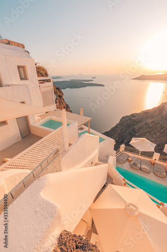 White architecture over street and sea view. Tranquil summer travel and vacation. Beautiful sunset on Santorini island, Greece.