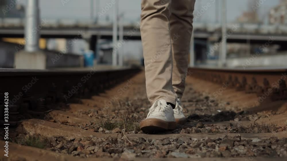 Man Walks To Home On Railroad Tracks After Canceled Public Transport .Tourist Legs Walking On Railway Middle Of Rail.Lonely Businessman Feet In Pants Walking On Rail Road When Train Or Tram Cancelled Man Walks To Home On Railroad Tracks After Canceled Public Transport .Tourist Legs Walking On Railway Middle Of Rail.Lonely Businessman Feet In Pants Walking On Rail Road When Train Or Tram Cancelled