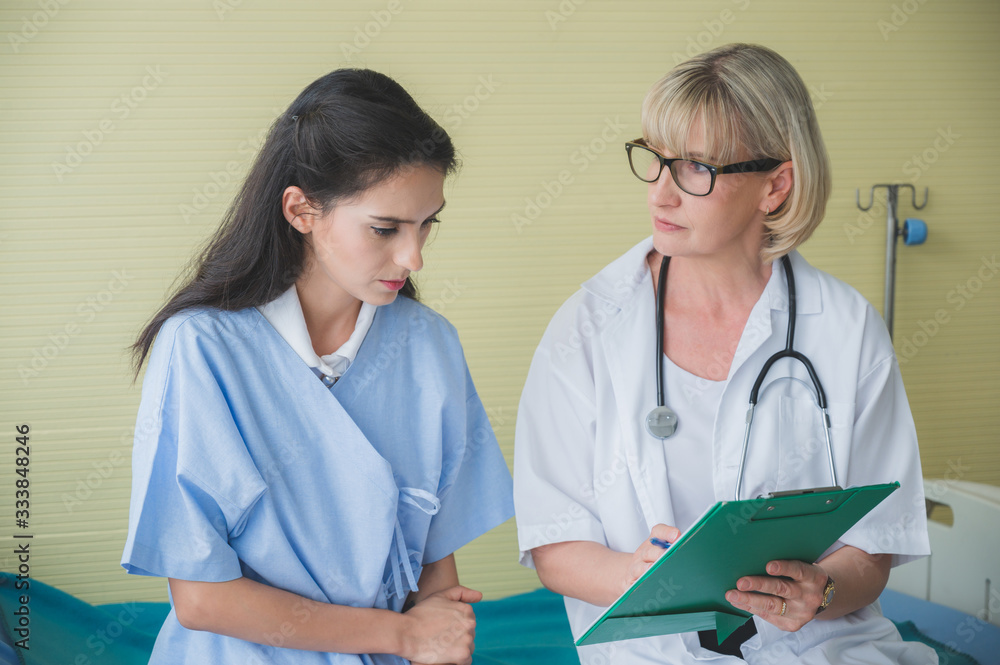 Senior female doctor meet the patient discussing consultation and making notes about symptom problem. Health care and client service in medicine concept. Senior female doctor meet the patient discussing consultation and making notes about symptom problem. Health care and client service in medicine concept.