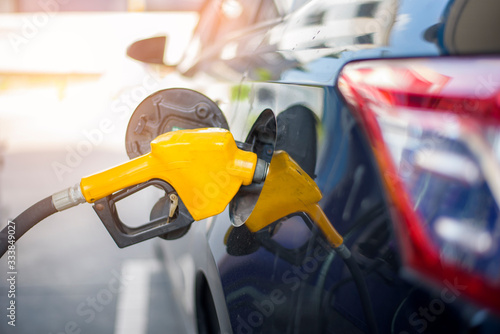 Close up of car is refilling oil fuel in Gas Station photo