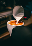 Barista hand making cappuccino Coffee with espresso machine in cafe
