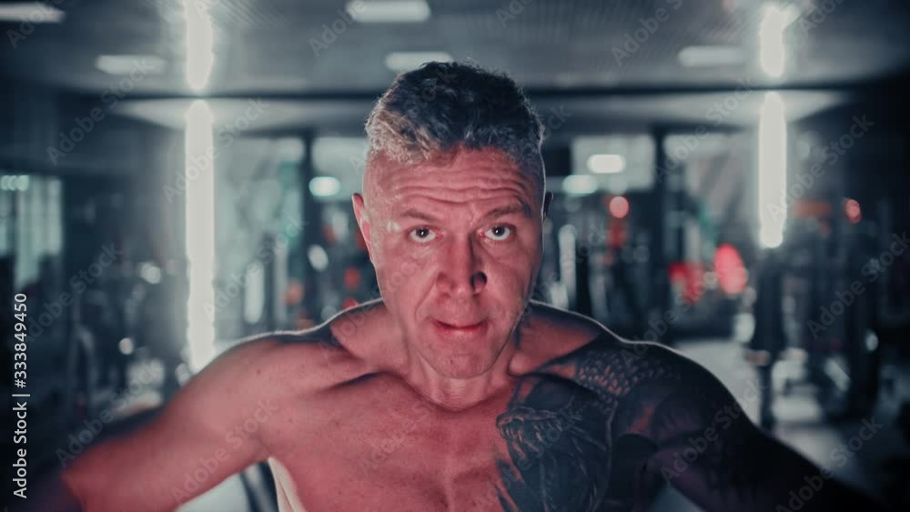Tough man with gray hair training his hands in the gym Tough man with gray hair training his hands in the gym