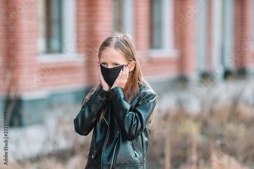 Girl wearing a mask on a background of a modern building,