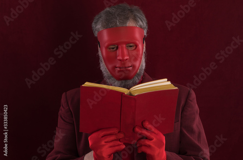 portrait of a man in red clothes and a red mask photo