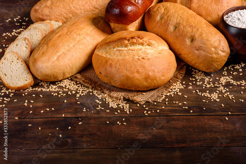 Fresh baked white bread on a brown concrete background