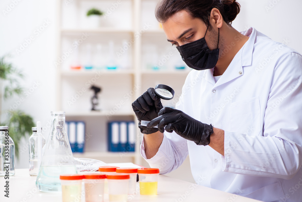 Young male chemist working in the lab Young male chemist working in the lab