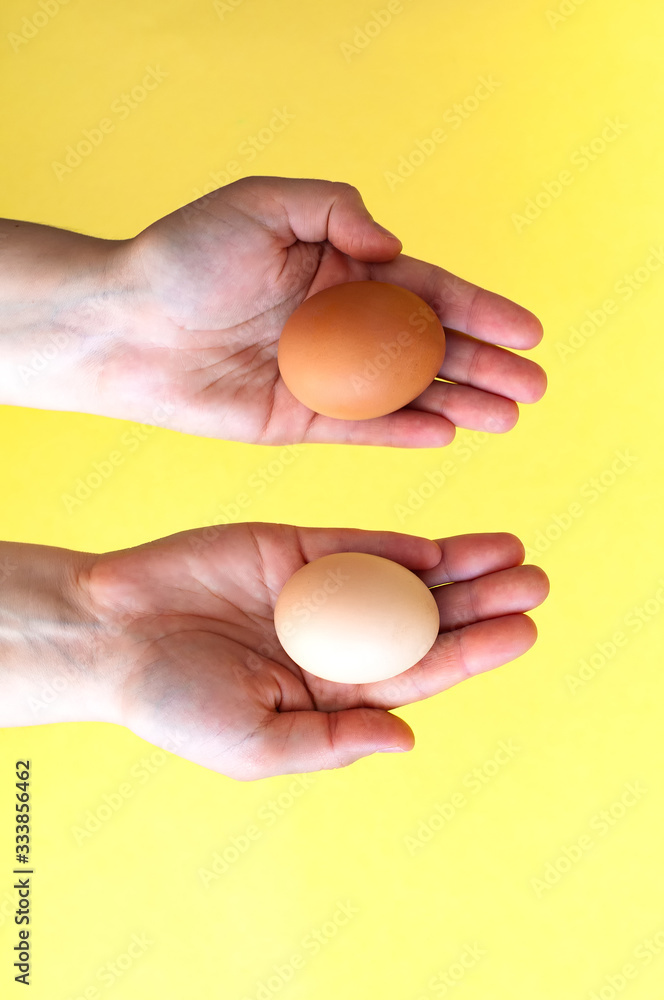 Woman hands holding two easter egg for choice Woman hands holding two easter egg for choice