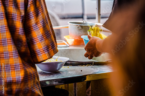 Street food vendors preparing pad thai in Bangkok, Thailand