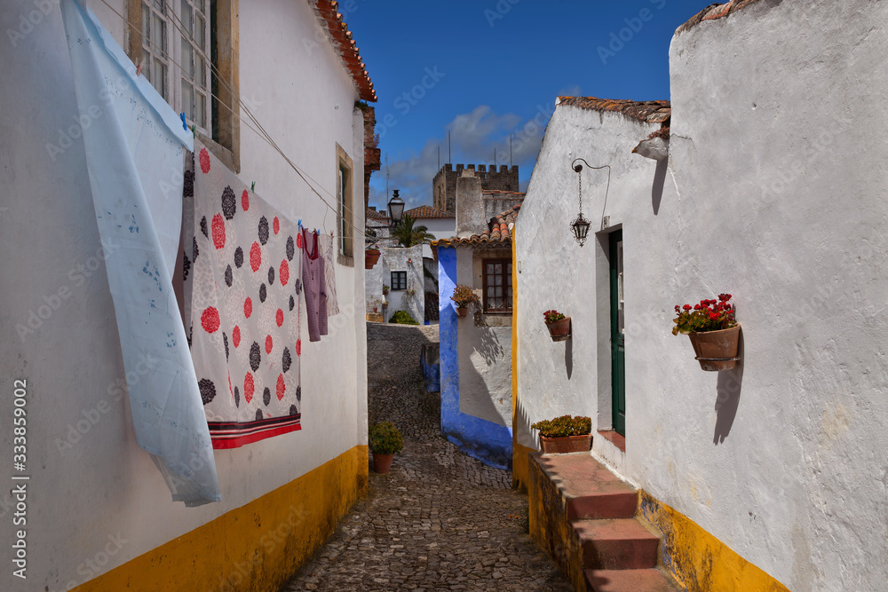 Fototapeta premium Old whitewashed houses in the medieval fortress of Obidos, Portugal