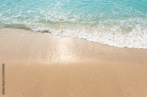 Blue ocean waves Sunlight Reflection Sand Beach background © wisoot