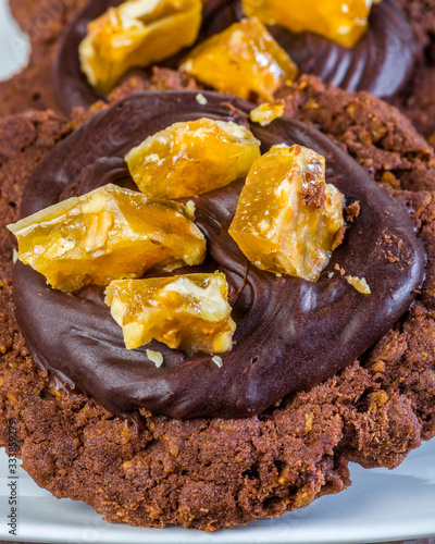 A 'Chocolate Afghan'  cookie covered with chocolate topping and pieces of honeycomb.
