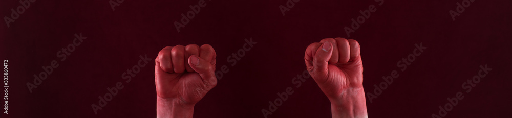close-up of painted red hands on a black background close-up of painted red hands on a black background