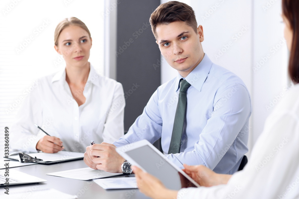 Group of business people or lawyers discussing terms of transaction in office. Colleagues working all together. Meeting concept Group of business people or lawyers discussing terms of transaction in office. Colleagues working all together. Meeting concept