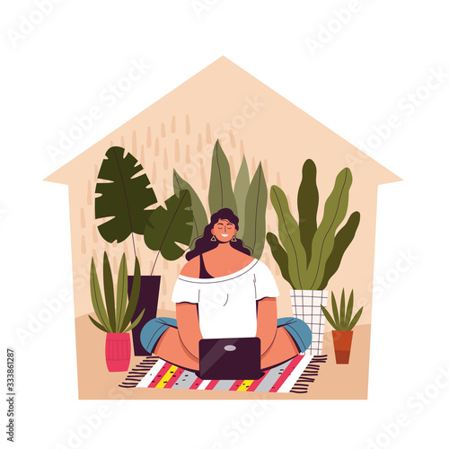 A young woman sits at home and works remotely. Concept activity and telecommuting, freelancing during quarantine and isolation of coronavirus