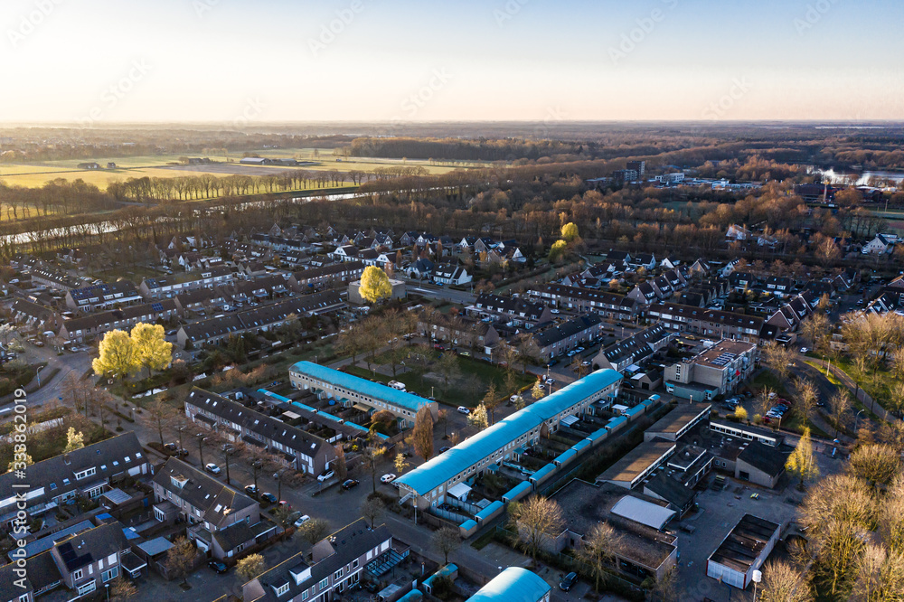 Fototapeta premium A residential area seen from above during a sunny sunrise in Waalwijk, Noord Brabant, Netherlands