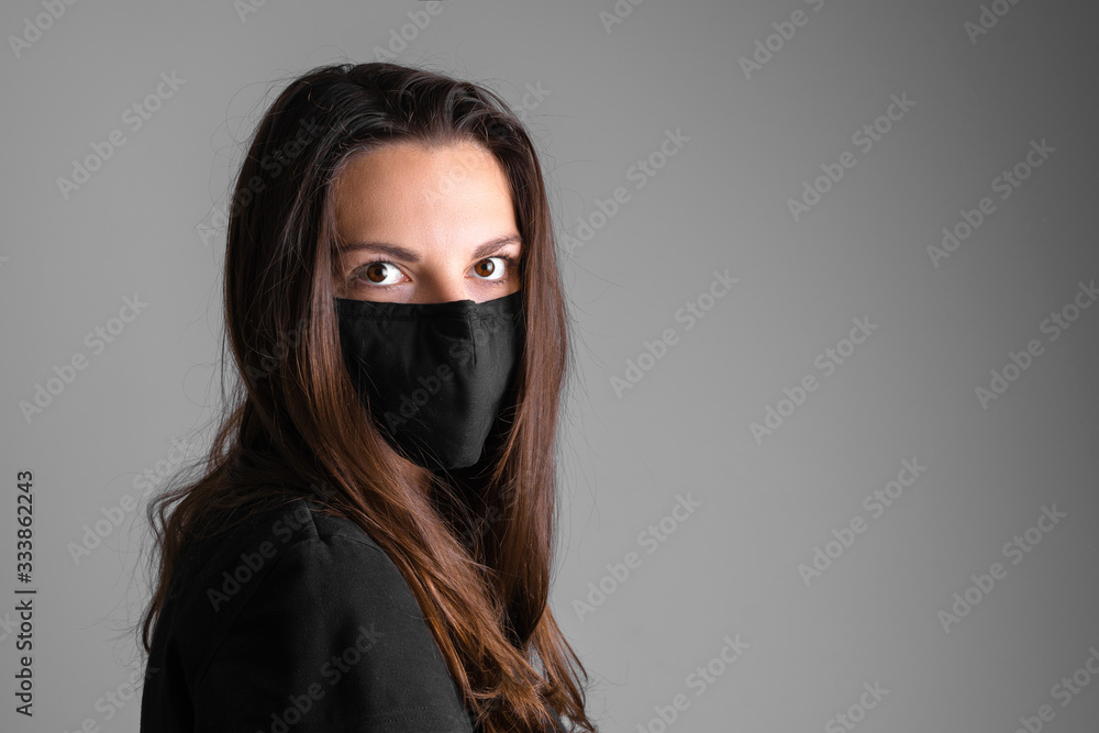 Young woman wearing black protective mask. Flu or virus pandemic. Allergy season Young woman wearing black protective mask. Flu or virus pandemic. Allergy season