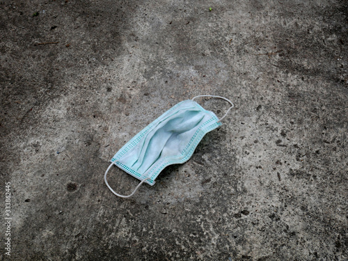 Wallpaper Mural used mask on the floor. dirty mask Wuhan corona virus. concept covid-19 Torontodigital.ca