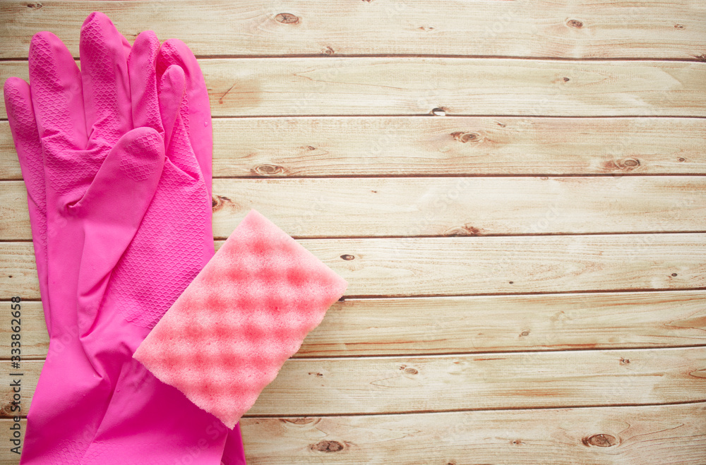 Flatlay, rubber gloves for cleaning the house, sponge on a wooden background. the concept of cleanliness sterility in the house Flatlay, rubber gloves for cleaning the house, sponge on a wooden background. the concept of cleanliness sterility in the house