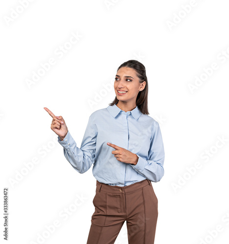 Smiling businesswoman pointing at copy space