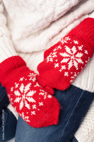Hands in red mittens