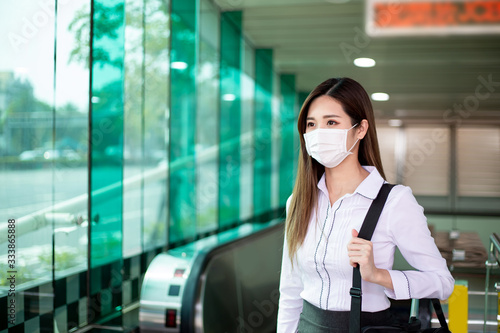 woman with mask in station