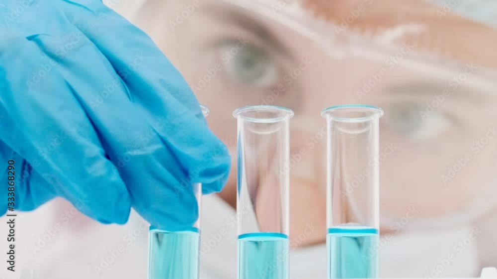 Blurred young woman scientist in a medical mask and hat Blurred young woman scientist in a medical mask and hat