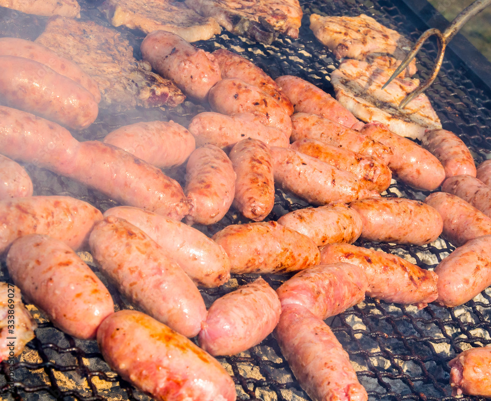 sausages and pork steaks on the large barbeque sausages and pork steaks on the large barbeque