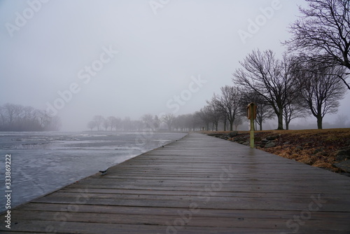 Quiet community park covered in dense fog during cold winter to spring season day © Aaron