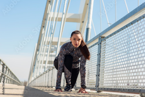 Determined young woman ready for a sprint