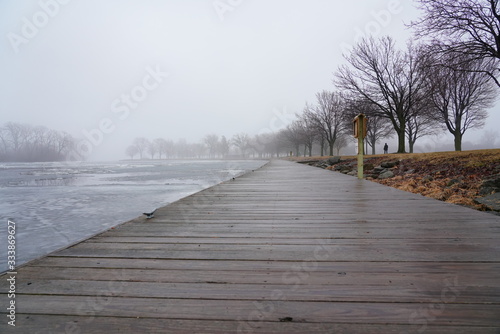 Quiet community park covered in dense fog during cold winter to spring season day
