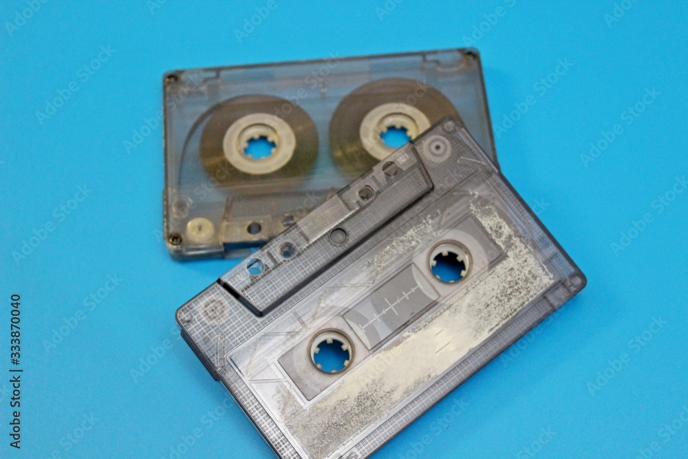 Old audio cassettes are located on a blue background Old audio cassettes are located on a blue background