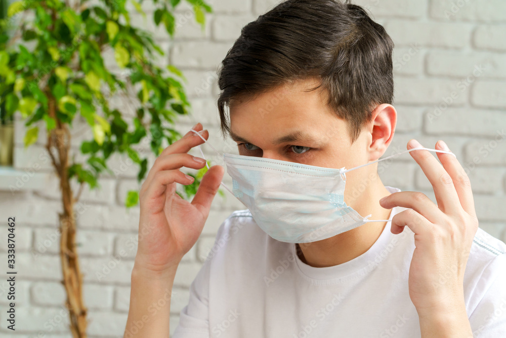 Sick man with medical protective mask on his face working in office. Coronavirus outbreak concept Sick man with medical protective mask on his face working in office. Coronavirus outbreak concept
