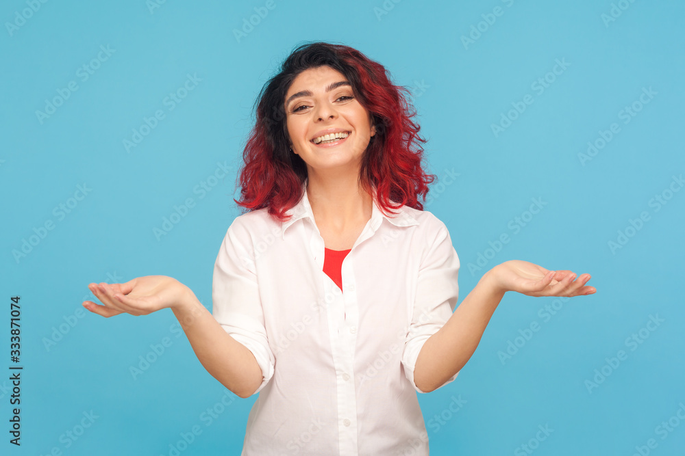 Let's embrace! Portrait of positive friendly woman with fancy red hair in white shirt keeping hands up giving free hugs, welcoming with toothy smile. indoor studio shot isolated on blue background Let's embrace! Portrait of positive friendly woman with fancy red hair in white shirt keeping hands up giving free hugs, welcoming with toothy smile. indoor studio shot isolated on blue background