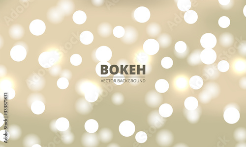 White bokeh lights on a yellow gold background. Holiday glowing white lights with sparkles. Defocused festive lights. Blurred bright abstract bokeh on light background.