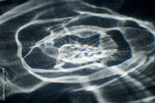 abstract light glow, lens flare, caustics water glas reflections. light through a prism. black background.