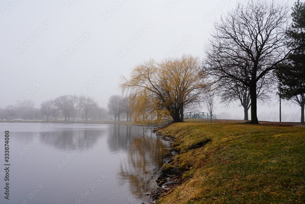 Quiet community park covered in dense fog during cold winter to spring season day