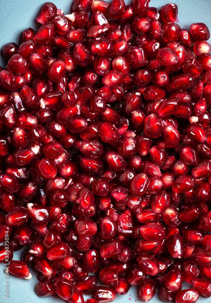 Pomegranate seeds in blue plate. Garnet seeds. Macro shot. Pomegranate seeds in blue plate. Garnet seeds. Macro shot.