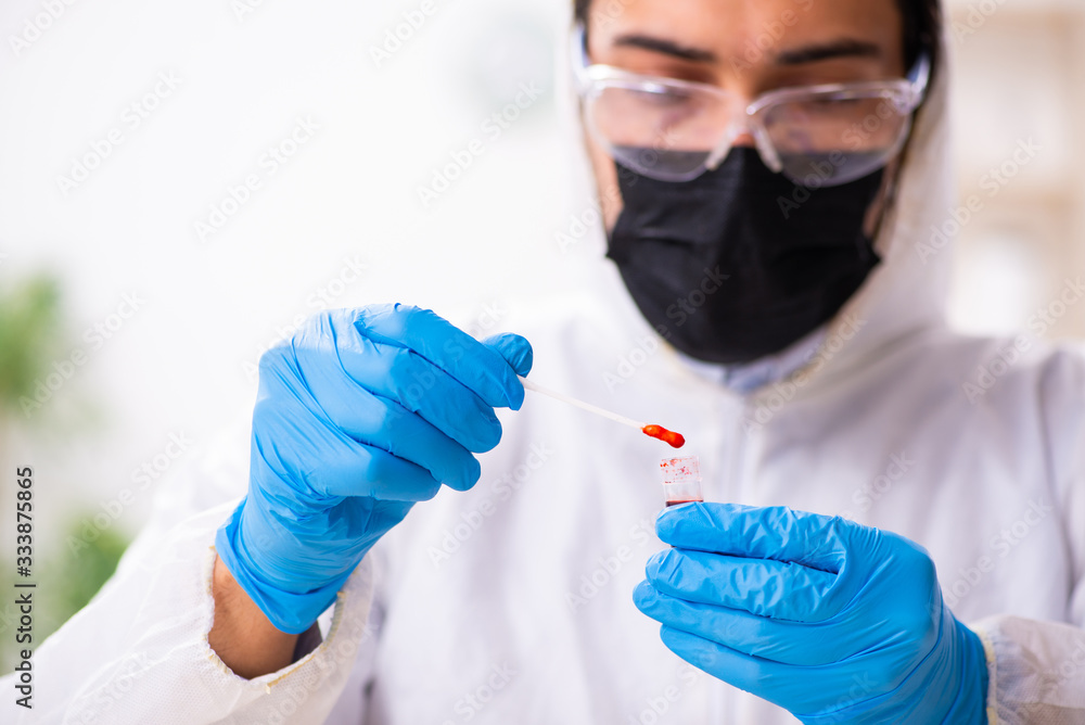 Male expert criminologist working in the lab for evidence Male expert criminologist working in the lab for evidence