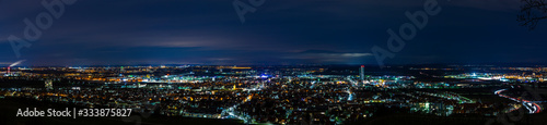 Germany  XXL panorama aerial view above houses  skyline and streets of fellbach city near stuttgart  illuminated cityscape by night